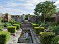 Tuto zapuštěnou anglickou zahradu se stříhanými buxusy a lekníny navrhl Robert Couturier (Foto: Tim Beddow)